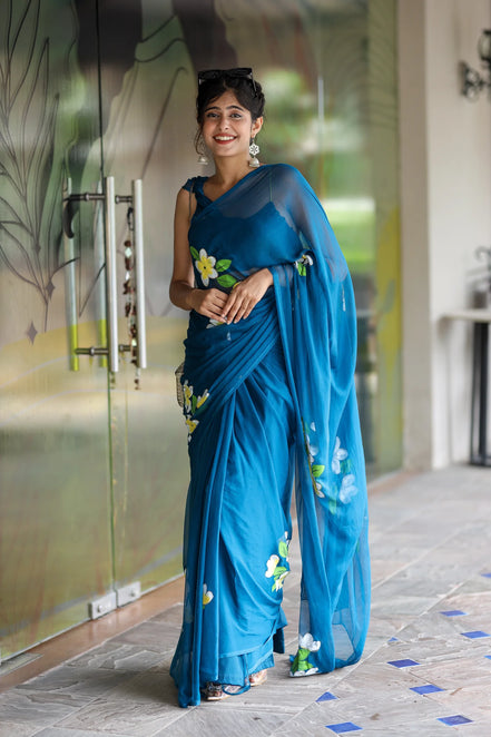 Nayantara Blue Chiffon Hand-Painted Saree – Frangipani Florals & Breezy Elegance