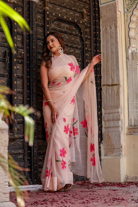 Iravya Peach Chiffon Saree – Hand-Painted Hibiscus Poetry